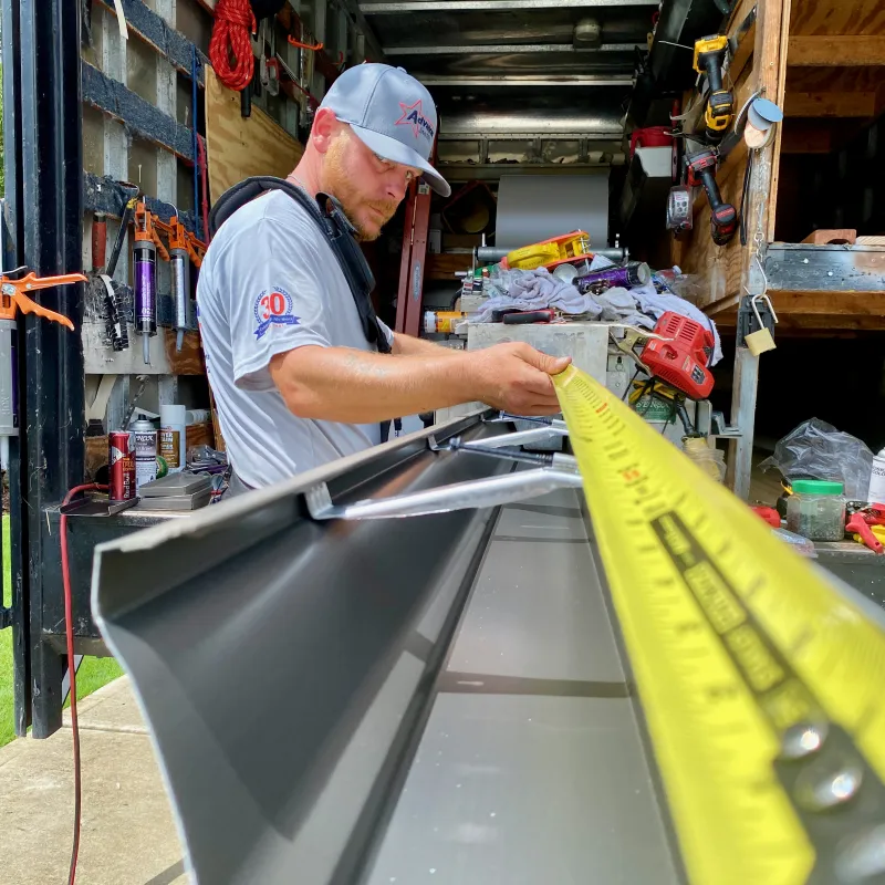 a man working on a gutter