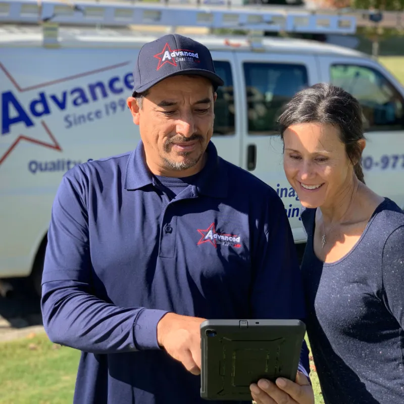 a man and a woman holding a tablet