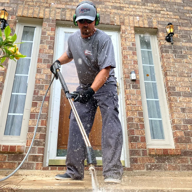 a man wearing a helmet and holding a hose