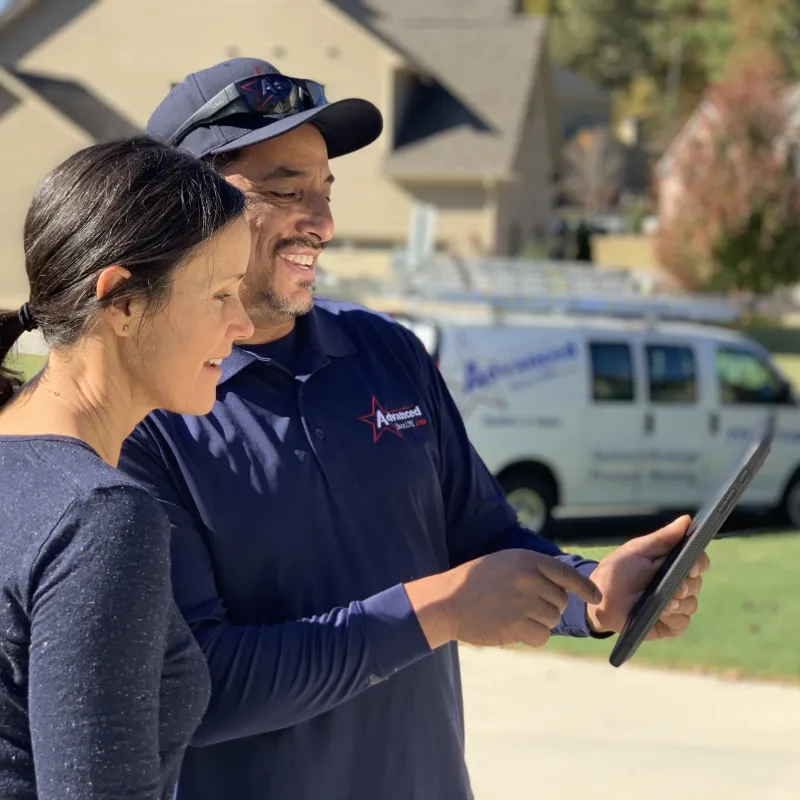 a man and a woman looking at a tablet