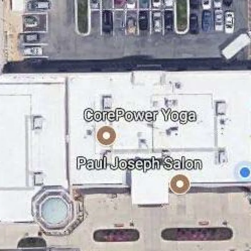 Aerial view of a shopping center including Whole Foods Market, HomeGoods, CorePower Yoga, and Murrmann Dental Health.