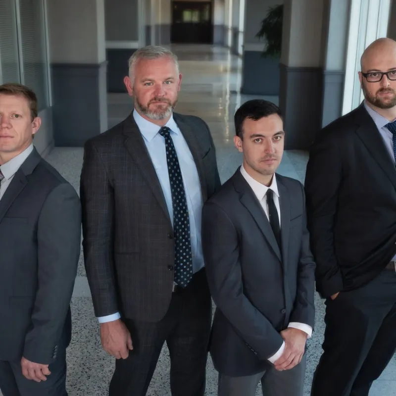 a man standing in front of a group of people posing for the camera