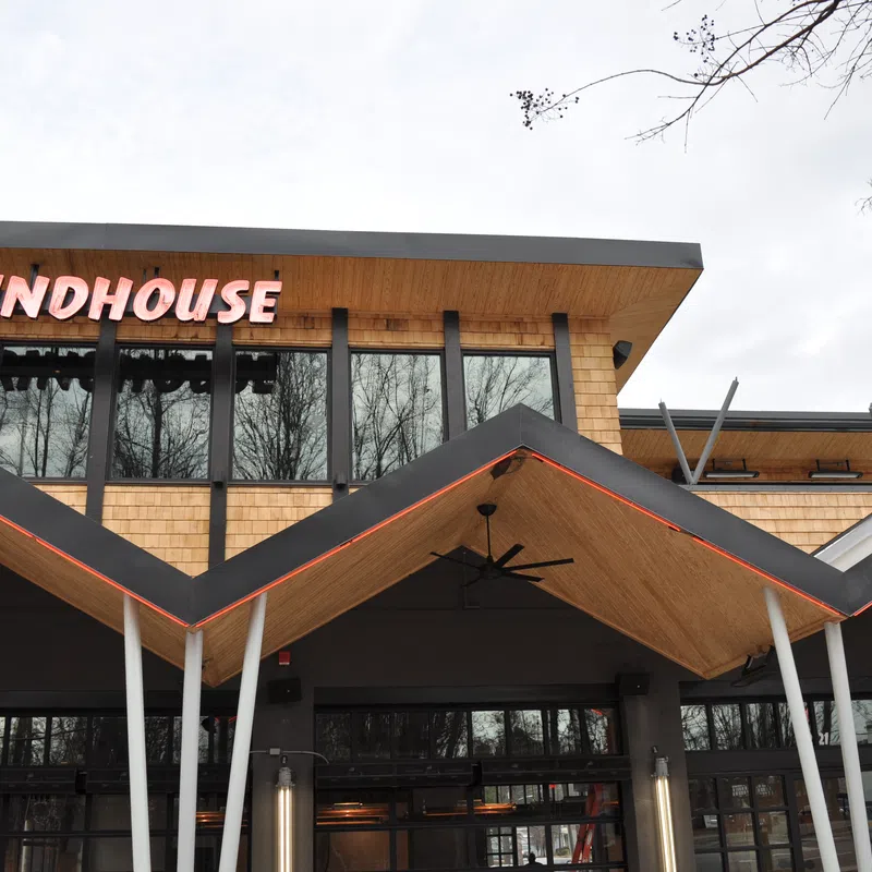 Modern Grindhouse cafe exterior with distinctive zigzag wooden roof and large windows on overcast day