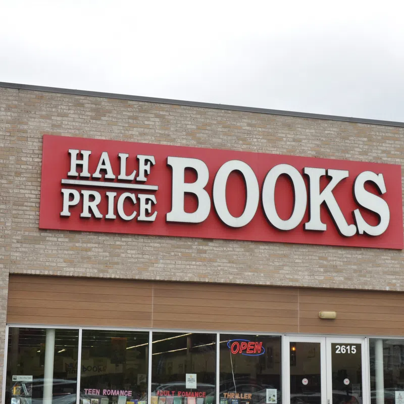 Half Price Books store front with red sign and glass windows showing book sections inside