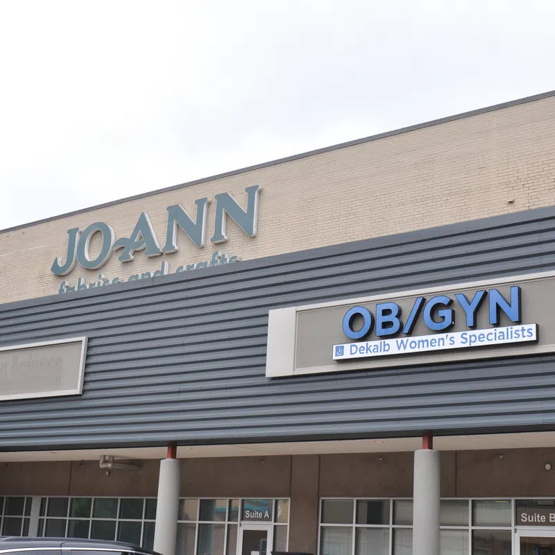 Exterior of a building with JO-ANN Fabrics and Crafts and OB/GYN Dekalb Women’s Specialists signs.
