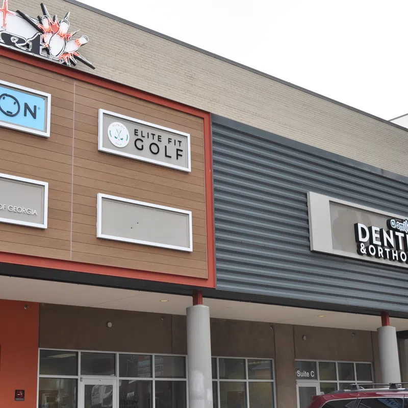 Shopping center facade featuring Kumon, Elite Fit Golf, Elite Radiology of Georgia, and Dentistry & Orthodontics signs.