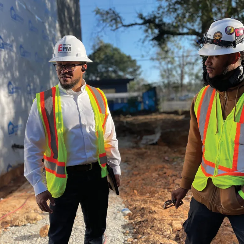 men wearing hardhats and reflectors