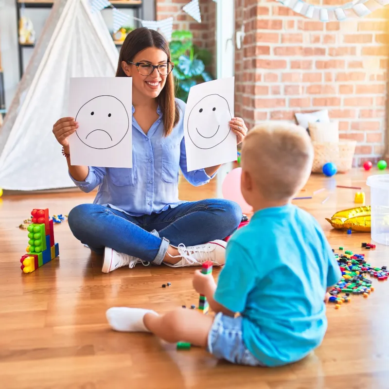 a person and a child playing with toys on the floor