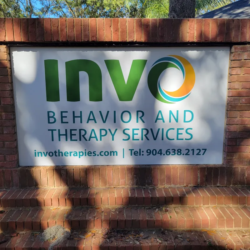 a sign on a brick wall