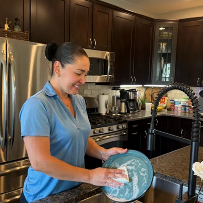 MaidPro Denver house cleaning professional cleaning dishes for a client in Lakewood, Colorado