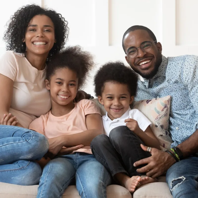 a family sitting on a couch