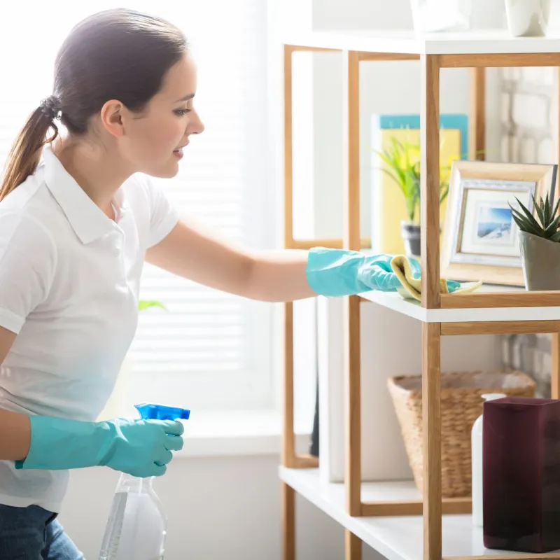 a woman in gloves holding a blue container