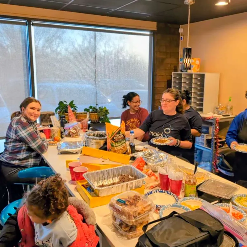 MaidPro Topeka Team enjoying a casual indoor meal
