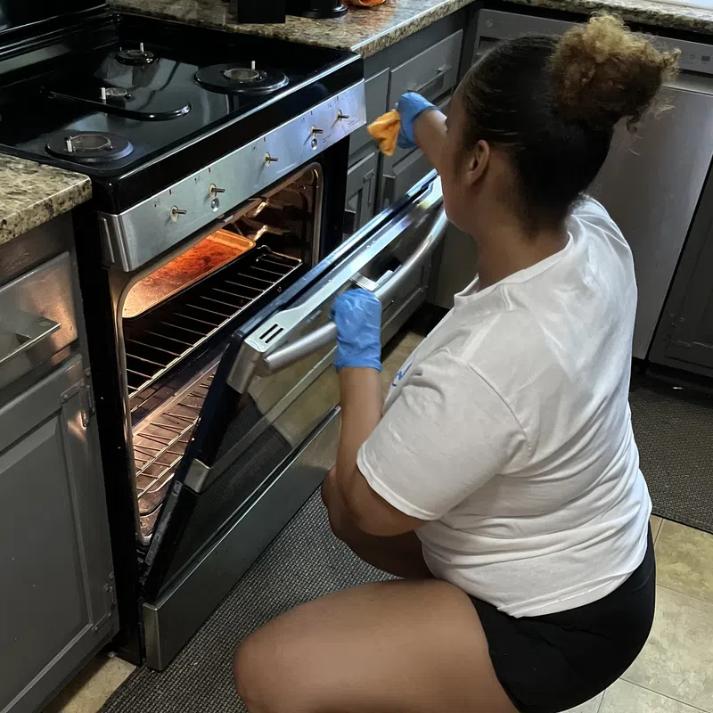 MaidPro Needham professional cleaning an oven in a home