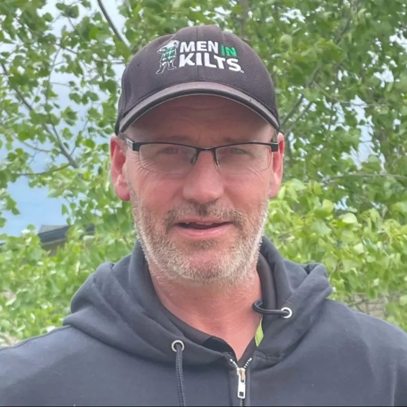 a man wearing glasses and a hat