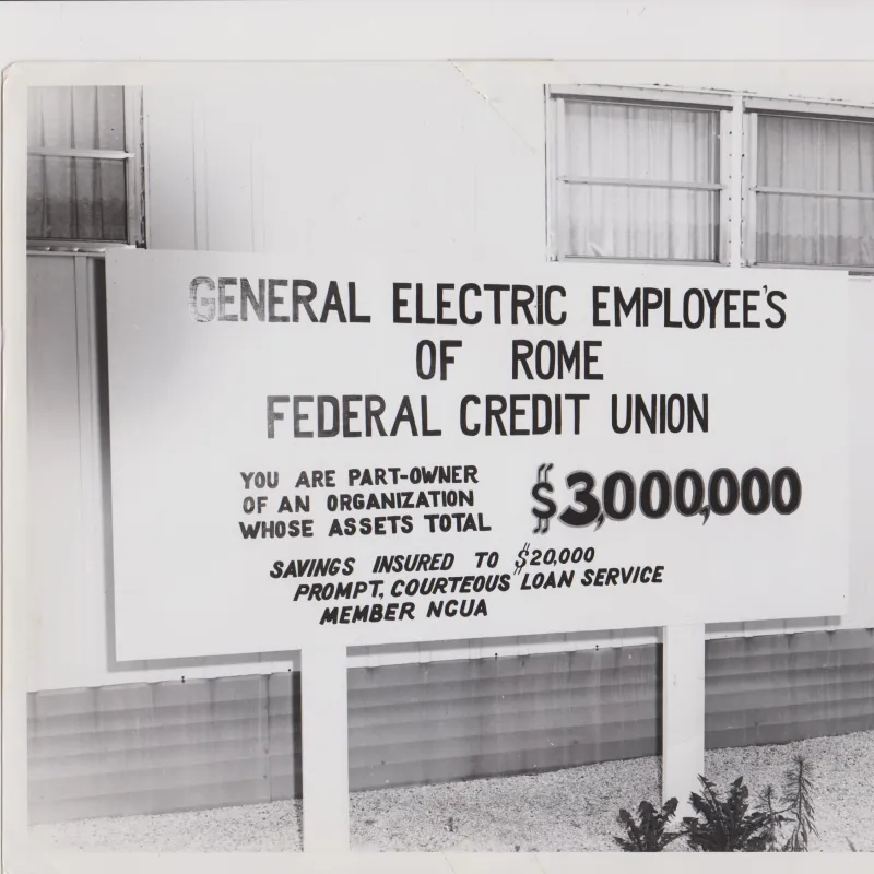 Vintage sign for General Electric Employees Federal Credit Union in Rome with $3,000,000 assets and member benefits.