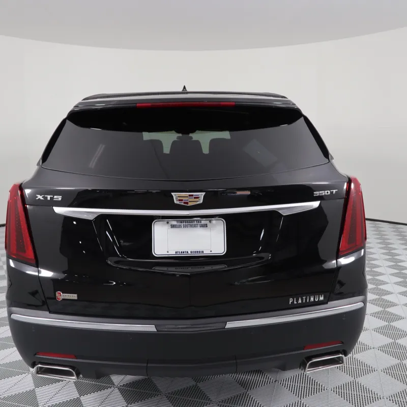 Rear view of a black Cadillac XT5 Platinum showcasing sleek design and modern features.