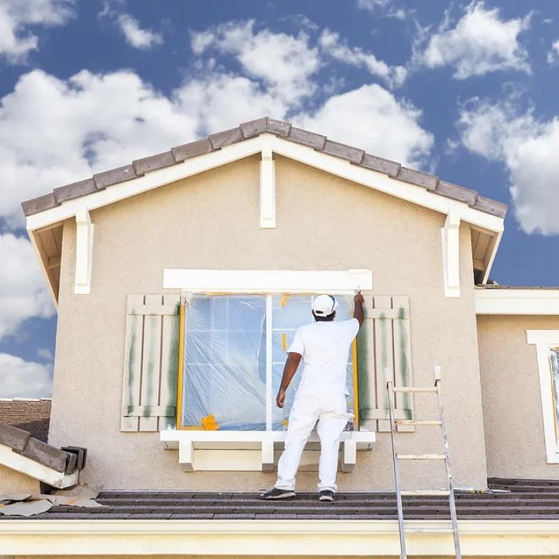 a person painting a house