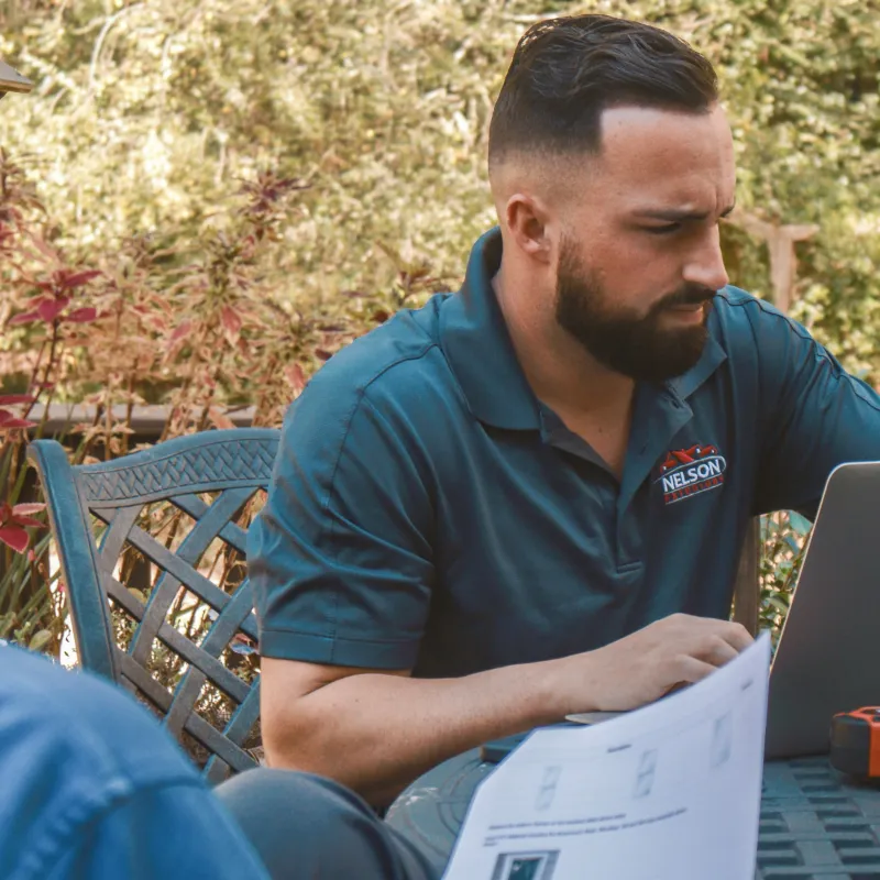 a man and a woman looking at a laptop