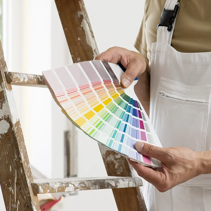 painter holding color swatch
