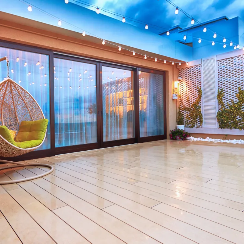 a room with a wood floor and a large glass door with a large window and a large glass