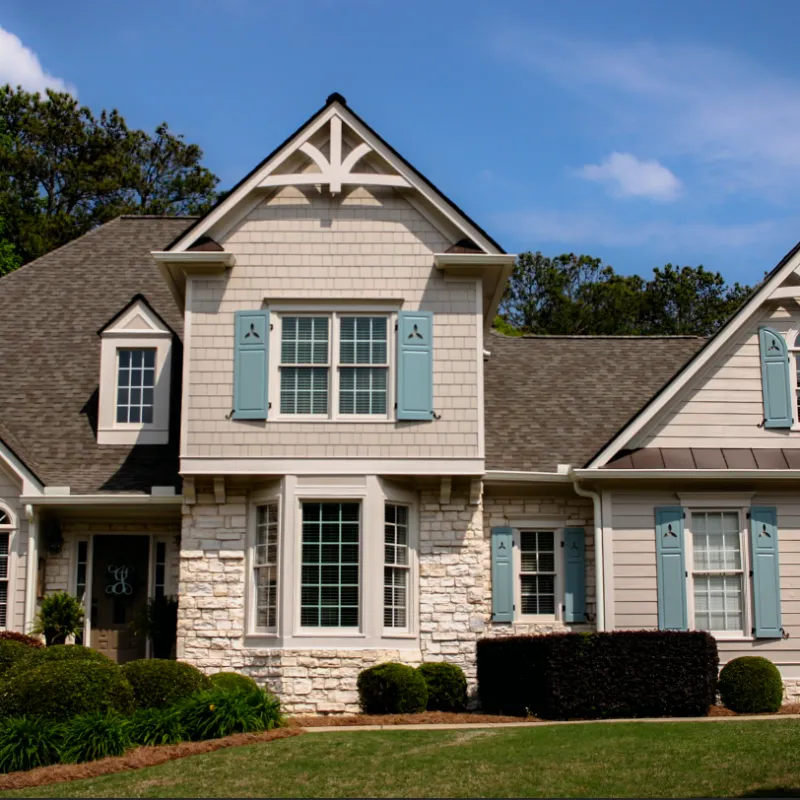 a large house with blue shutters