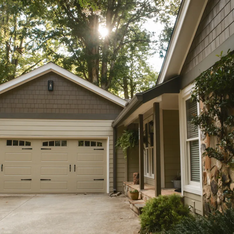 a house with a garage and trees