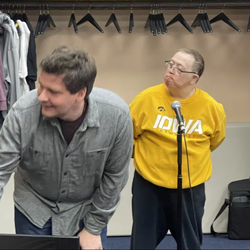 a person talking to another man