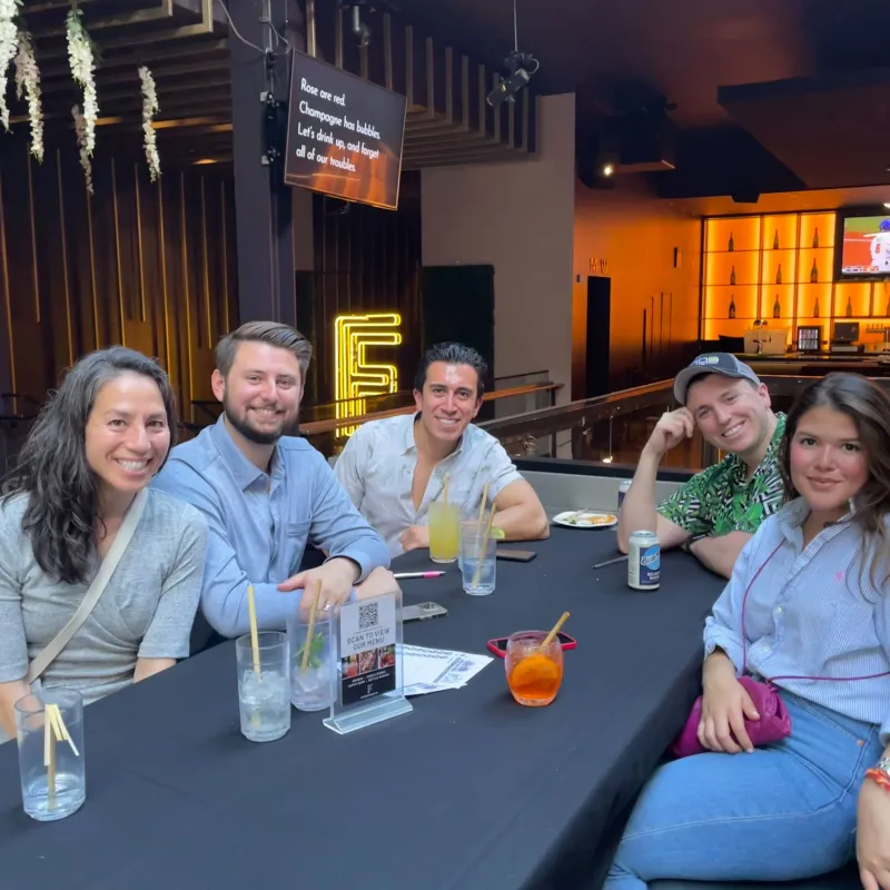 a group of people sitting at a table logo
