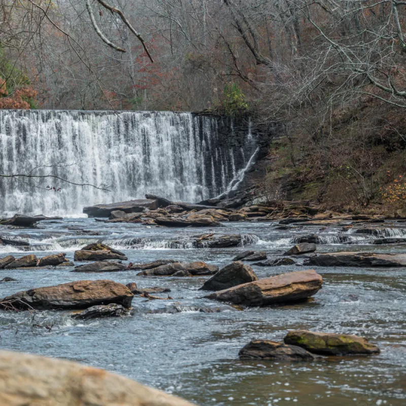 a river with rocks and a waterfall