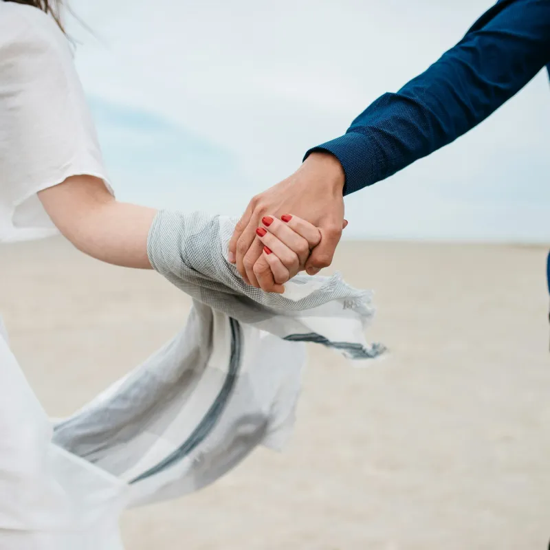 a man and woman holding hands