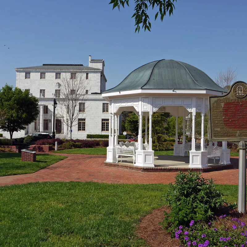 a white building with a green roof