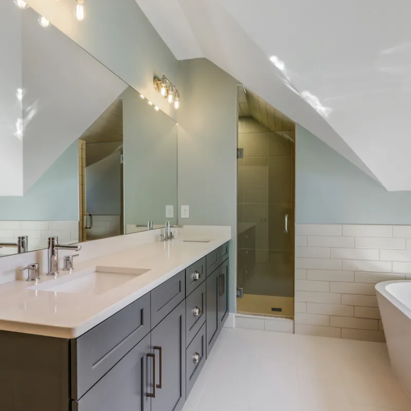 a bathroom with a tub sink and mirror
