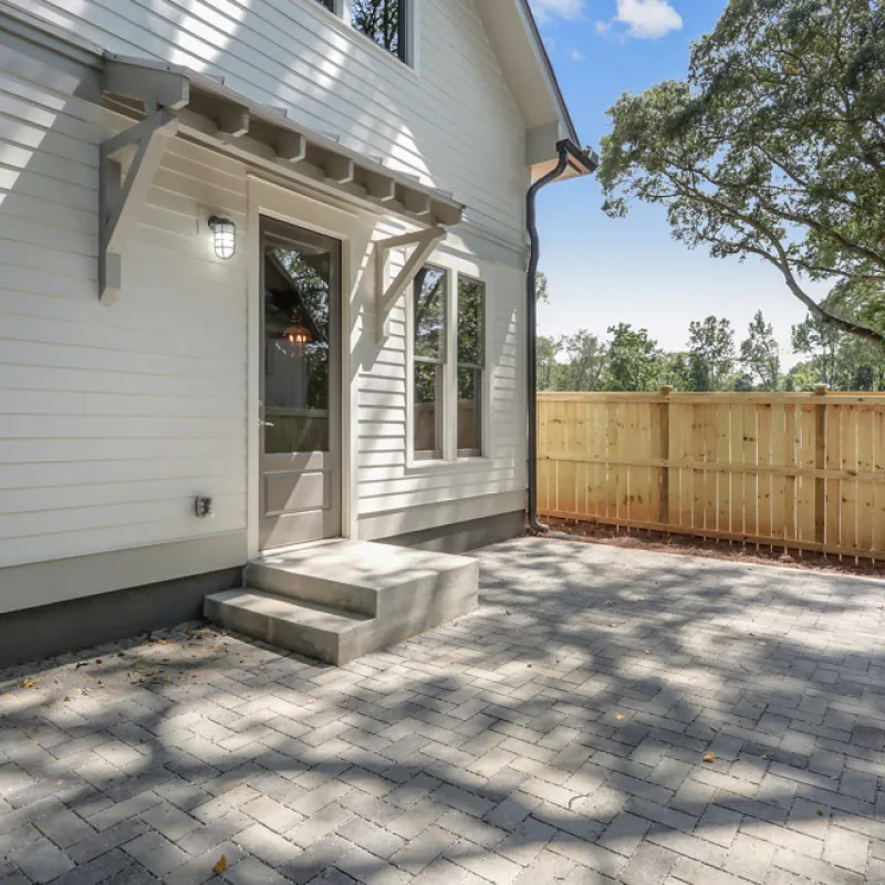 a house with a fence and a tree
