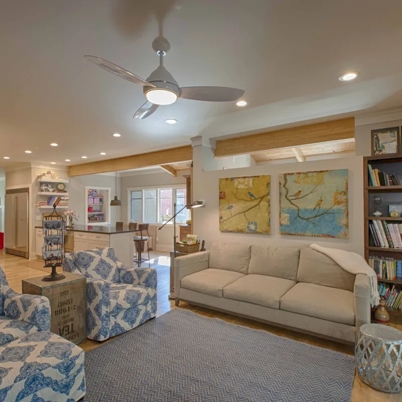 a living room with a fan and couches