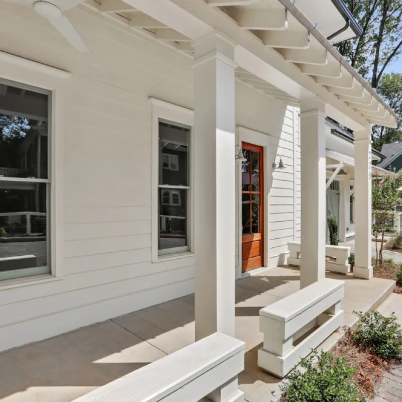 a white house with a stone patio