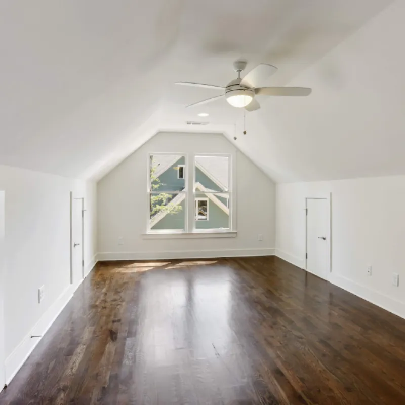 a room with a wood floor and a ceiling fan