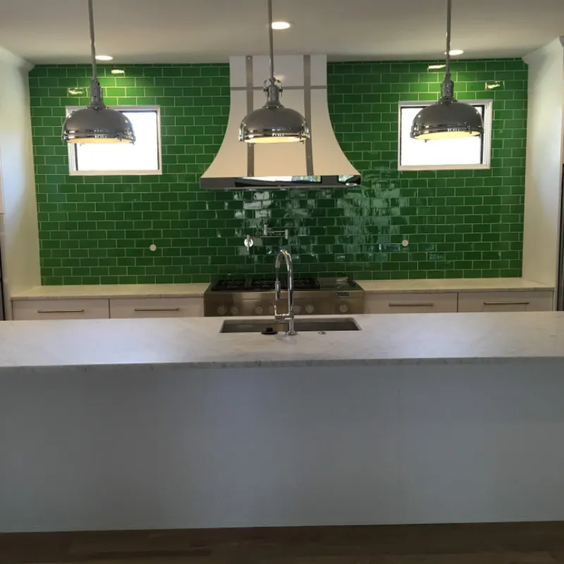 a kitchen with green walls
