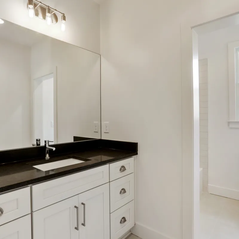 a bathroom with a black countertop