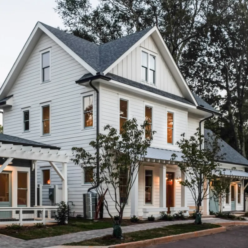 a white house with trees in the front