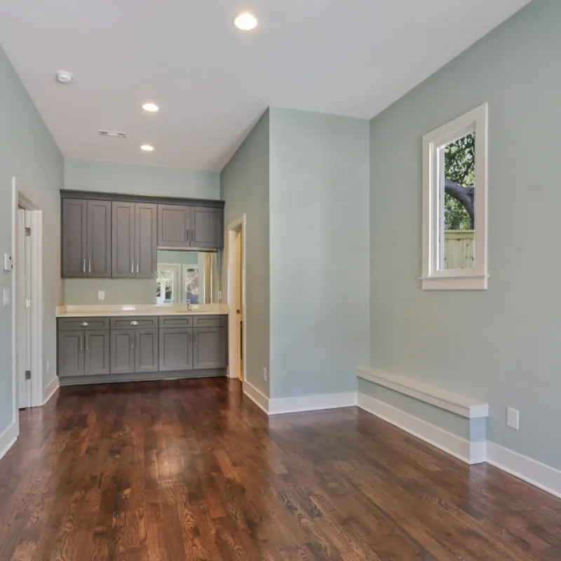 a room with a wood floor and white walls