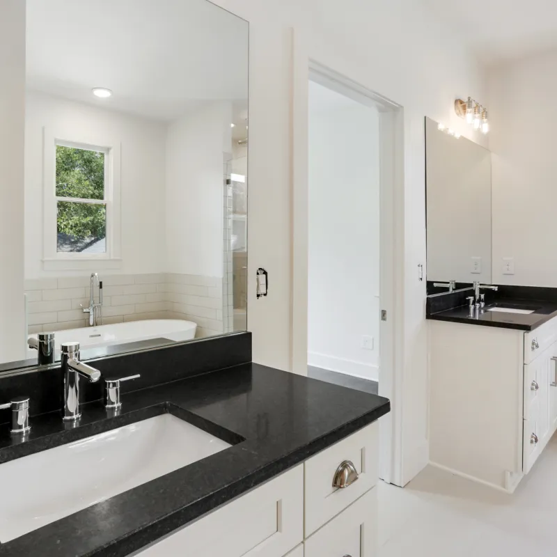 a bathroom with a large black countertop