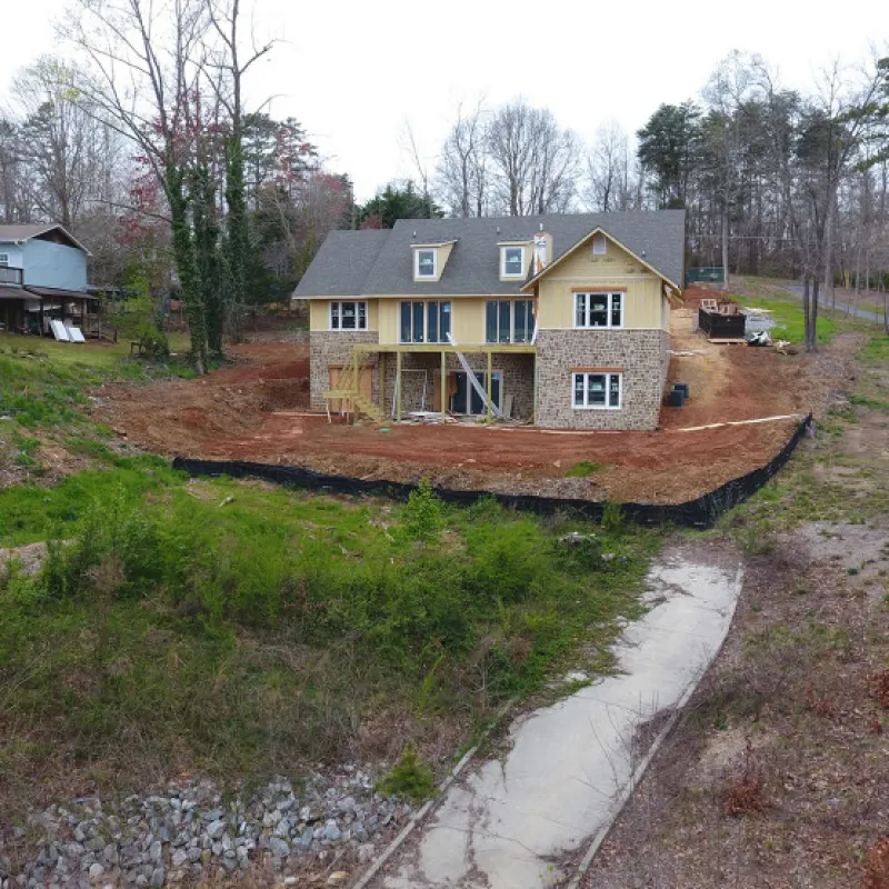 a dirt road leading to a house