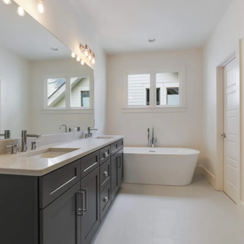 a bathroom with a tub sink and mirror