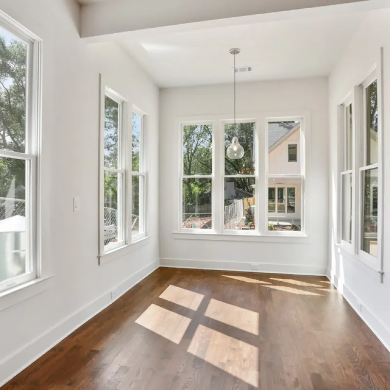 a room with windows and a rug