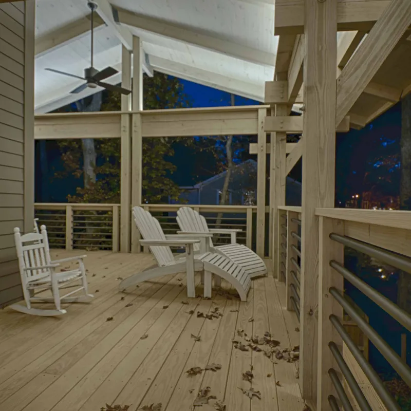 a group of white chairs on a wooden deck