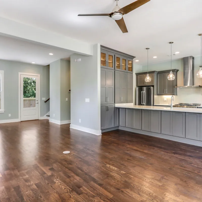 a large kitchen with a wood floor
