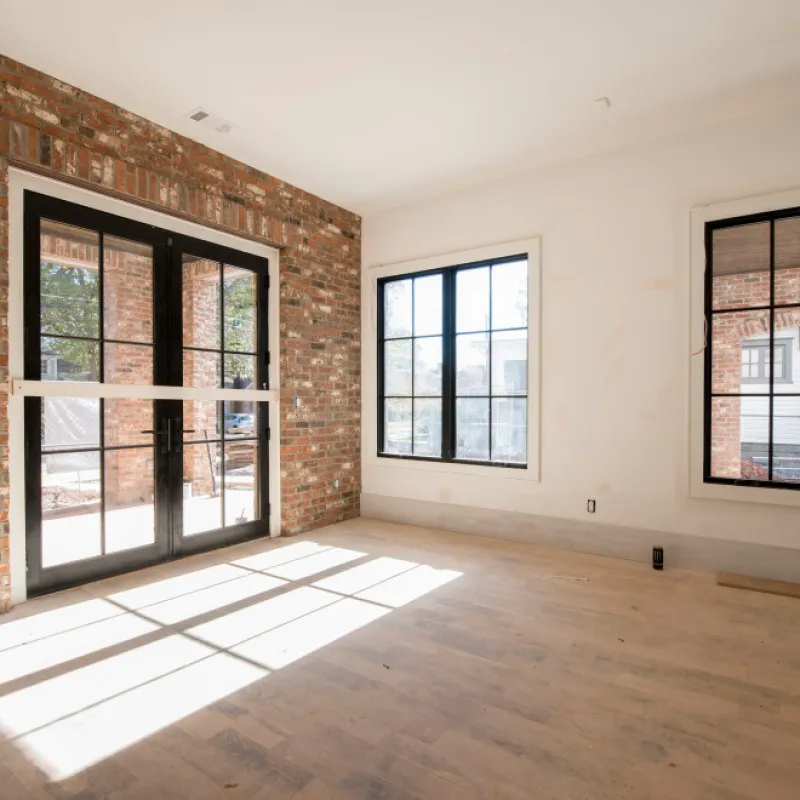 a room with a glass door and windows