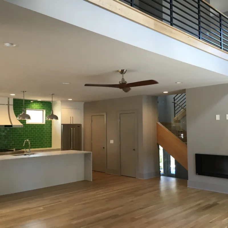 a room with a wood floor and a ceiling fan