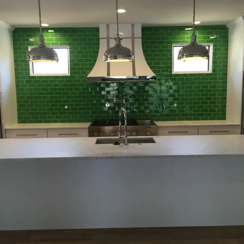 a kitchen with green walls